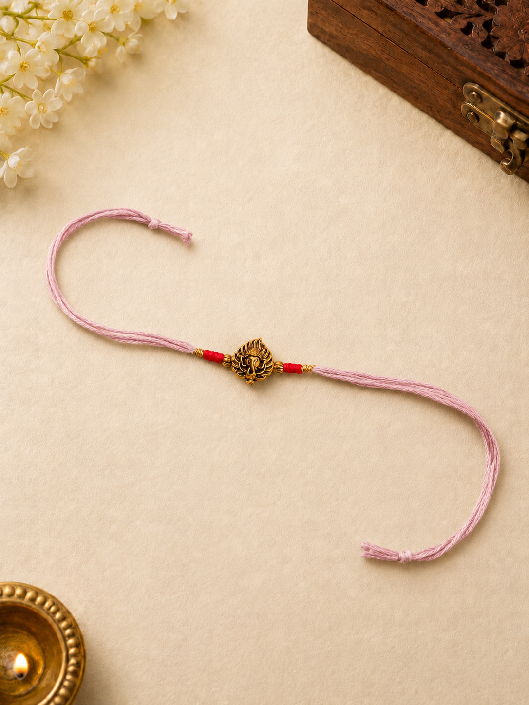 Pink Thread Rakhi with Antique Gold Ganesha Charm for Bhai