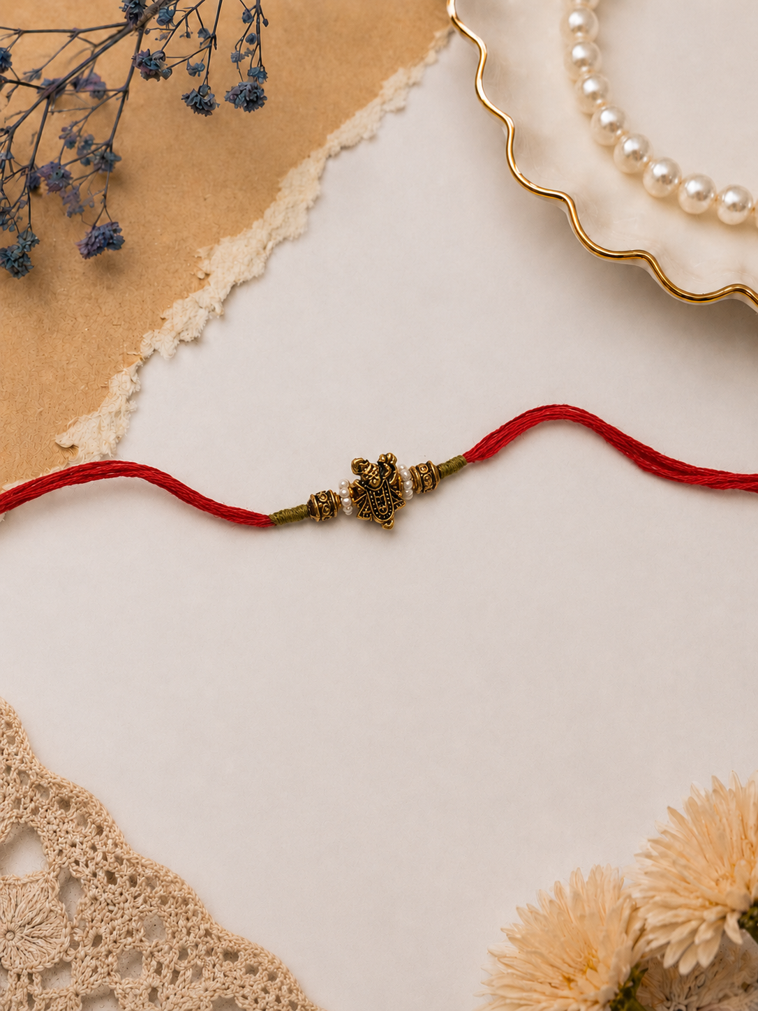 Red Thread Rakhi with Antique Ganesha Pendant for Brother