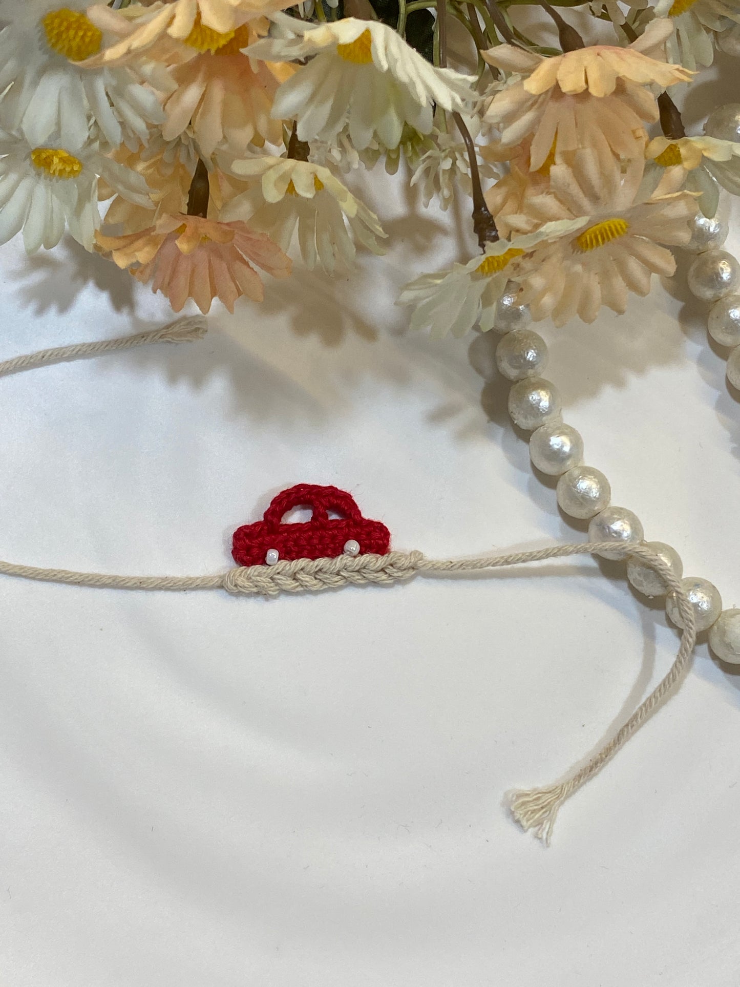 Handmade Red Crochet Car Rakhi for Kids | Cute Beige Thread Rakhi with Pearl Detailing