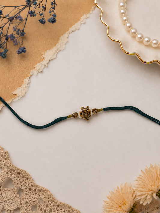 Dark Green Thread Rakhi with Antique Ganesha Pendant for Brother