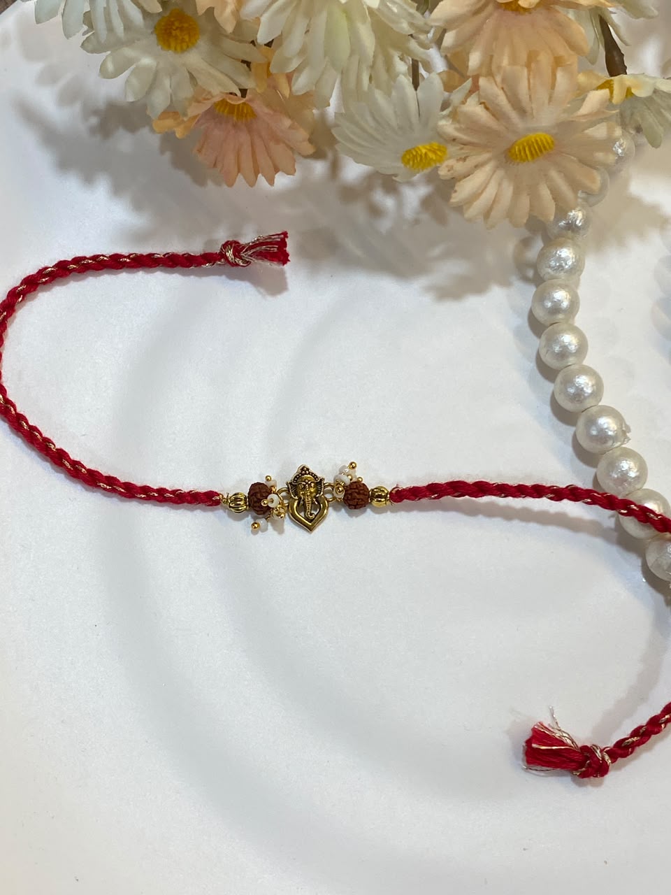 Ganesha Rudraksha Pearl Rakhi – Embellished Red Thread Rakhi for Brother