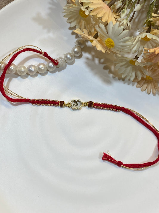 Ganesha Zircon Rudraksha Rakhi – Handwoven Red & Gold Thread Rakhi for Brother